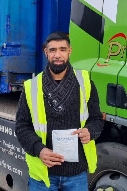 Man holding pass cerificate for HGV Driver Training Category C+E with PFS Training